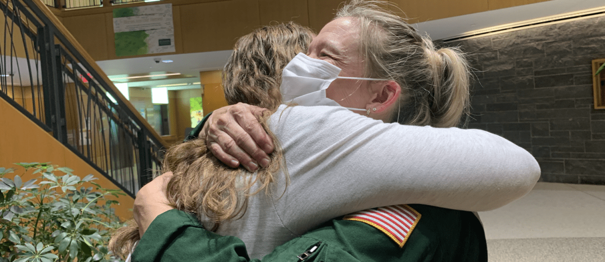 Missy McCann and Jenn Popper share a hug