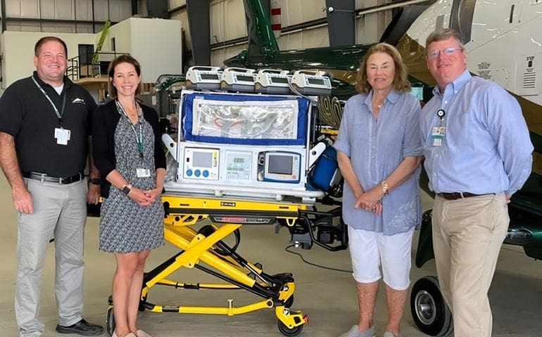 From left, Director of Clinical Operations Chuck Hogan, Director of Development Anna Dugal, CCRF Director Laurie Warren and COO Bill Cyr, flanking an isolette (or incubator) on a recent visit to LifeFlight of Maine’s Bangor base.