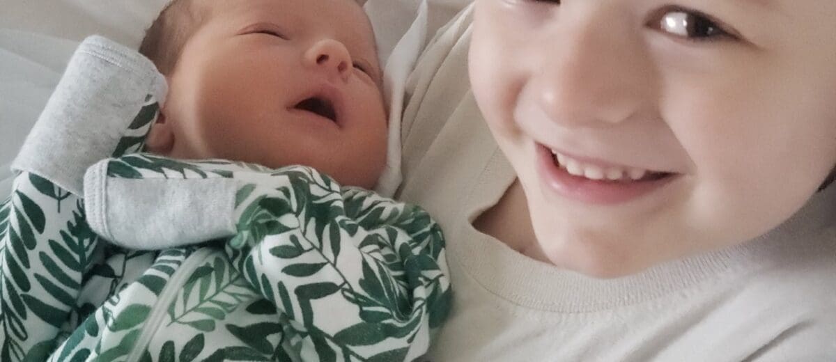 Sawyer holding baby Olivia for the first time