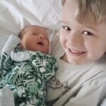 Sawyer holding baby Olivia for the first time