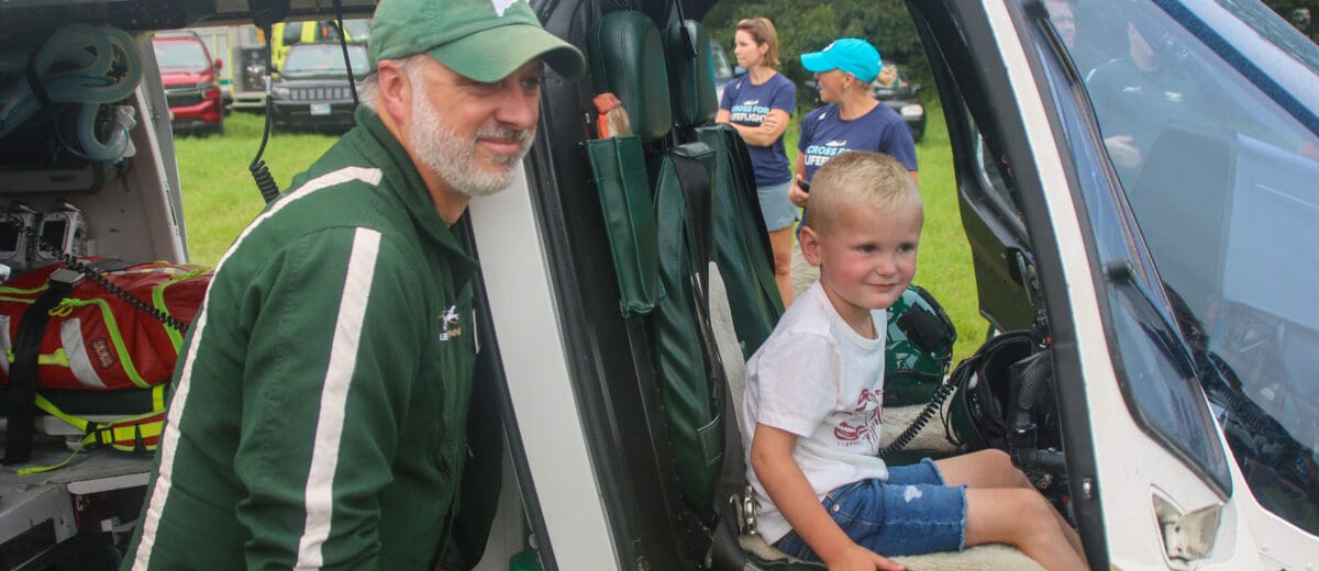 Rotor wing pilot Kirk Donovan with a young LifeFlight supporter.