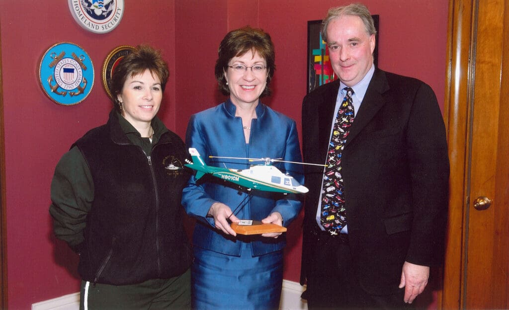Tom Judge, founding executive director of LifeFlight, and flight nurse Lori Metayer with Sen. Susan Collins in 2003.