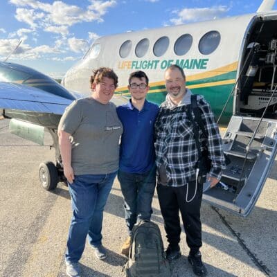 Eric Brasier poses with his wife and son in front of a LifeFlight airplane.