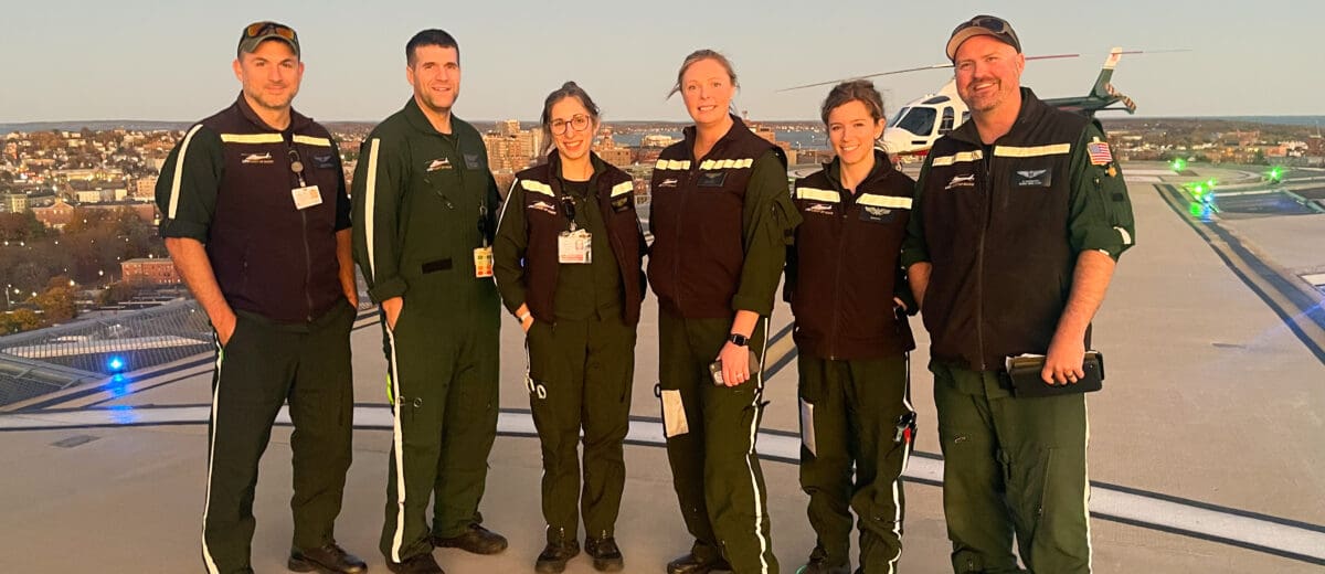LifeFlight crew members stand on a helipad.