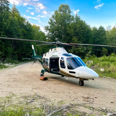A LifeFlight helicopter on a dirt road.