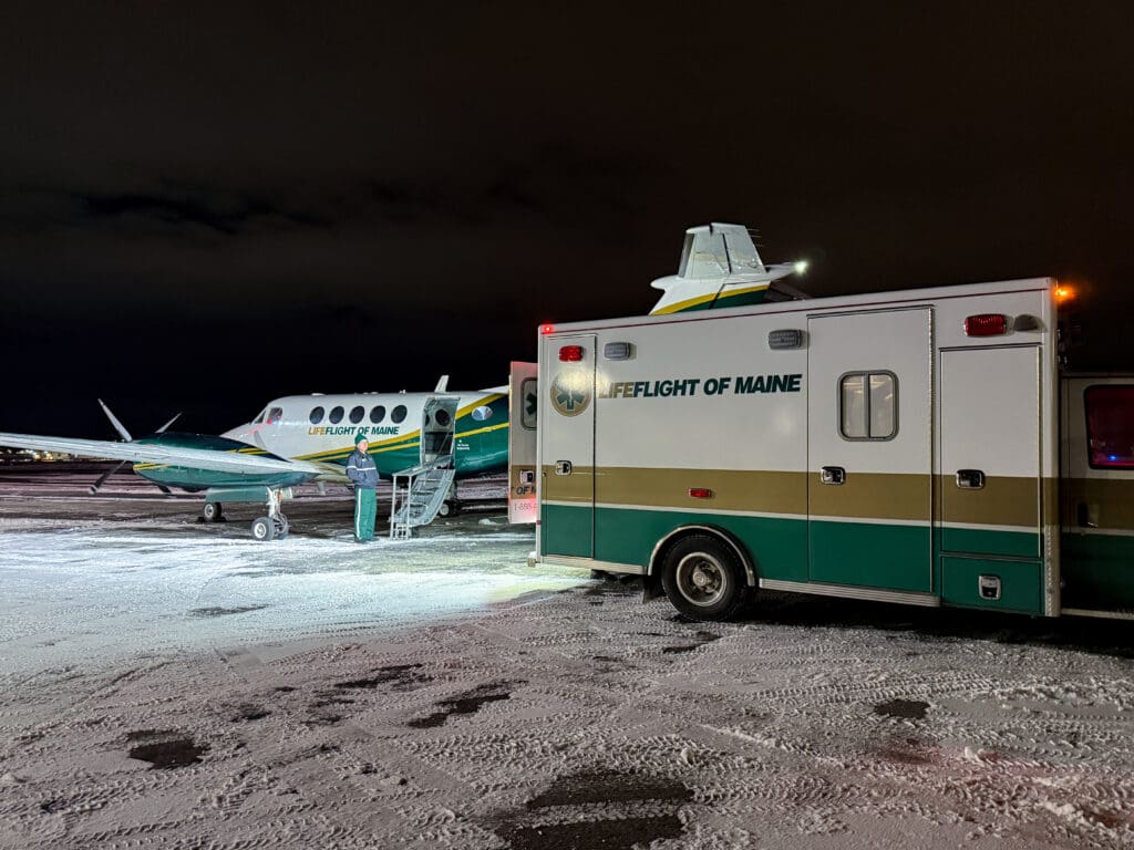 LifeFlight's airplane and ambulance on a snowy runway.