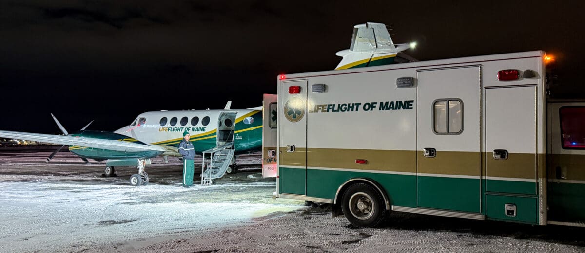 LifeFlight's airplane and ambulance on a snowy runway.
