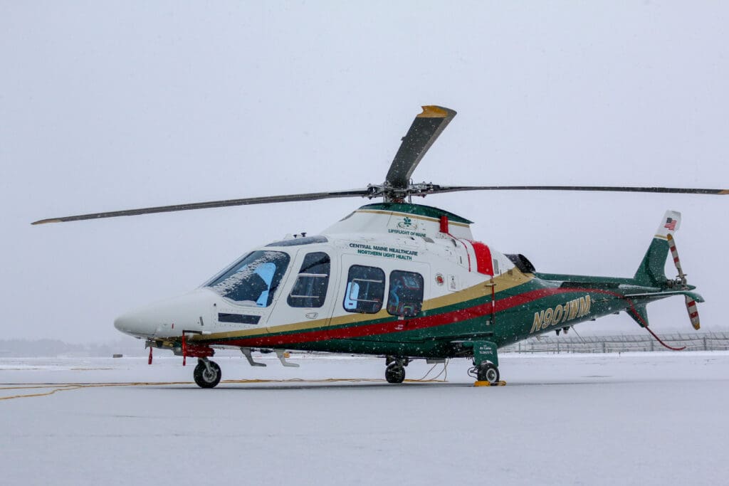 A LifeFlight helicopter on the ground in the snow.