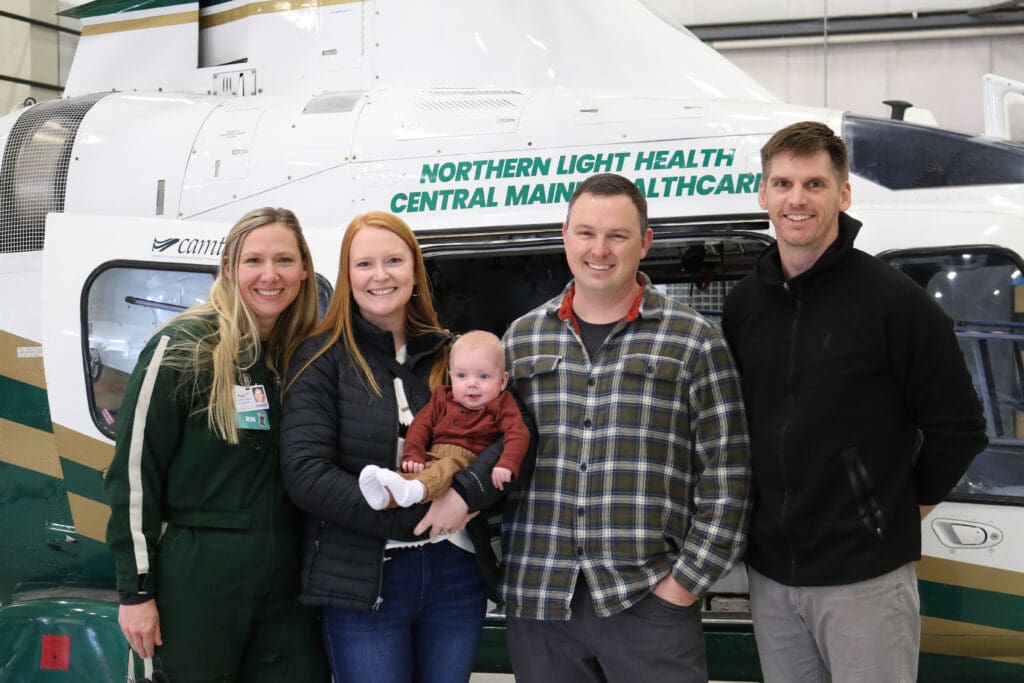 Flight nurse Denise Saucier, April White, Oliver White, Max White, and flight paramedic Brad Alleger at LifeFlight's hangar.