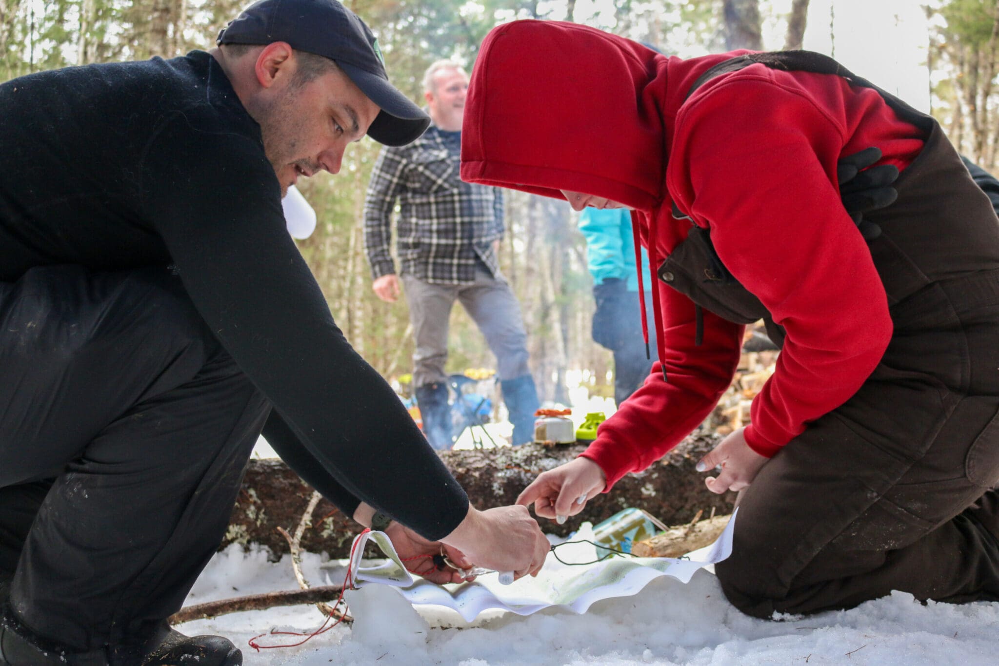 Crew members navigating using a map and compass.