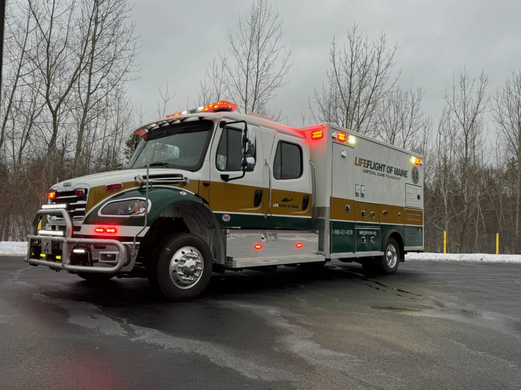 A LifeFlight ambulance with its lights on.