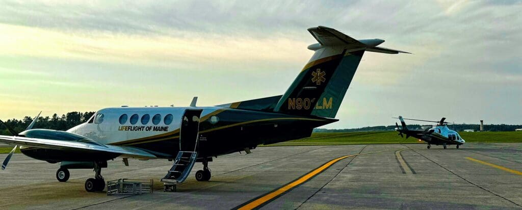 A LifeFlight plane and helicopter on the runway.