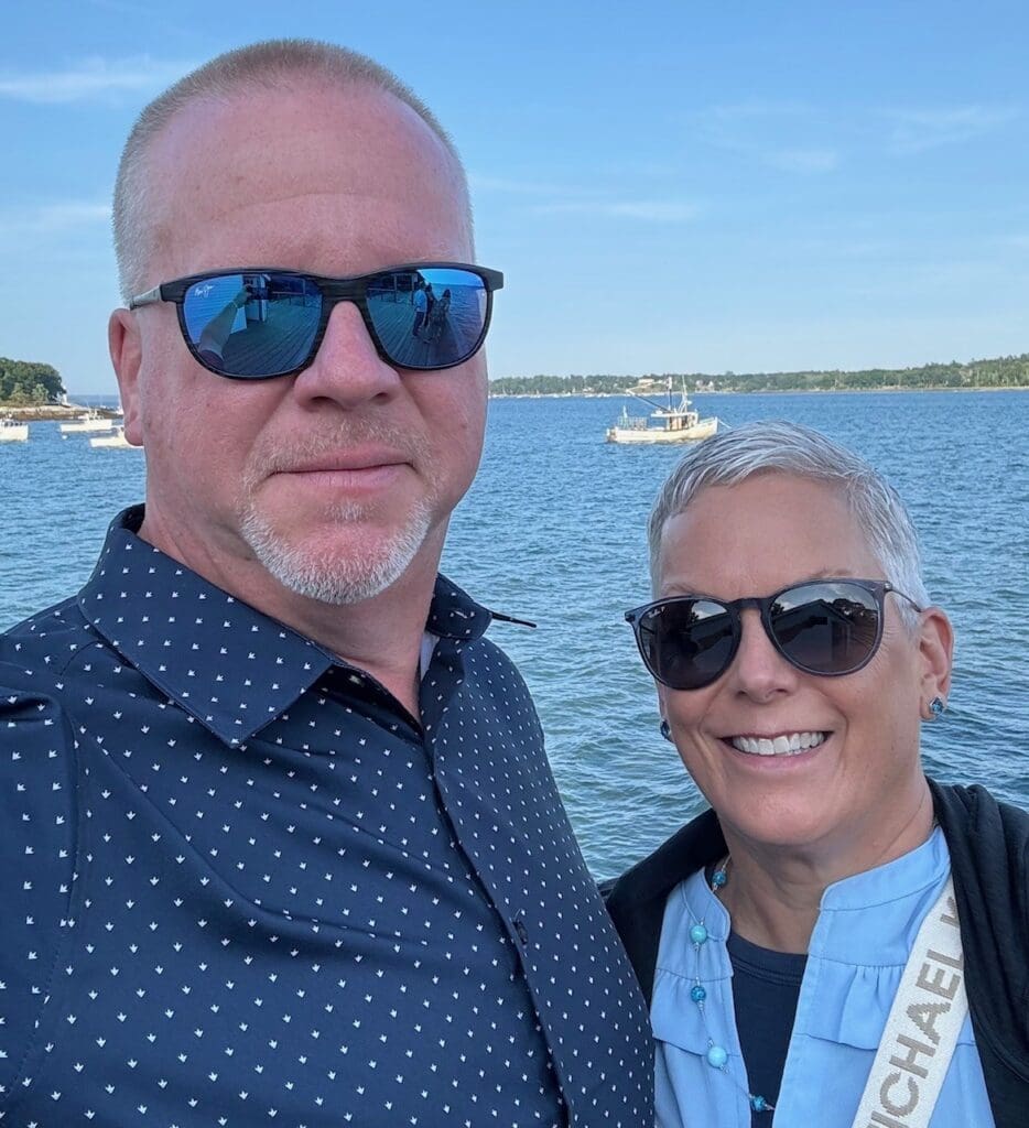 Shawn and Leslie Anderson stand in front of the ocean.