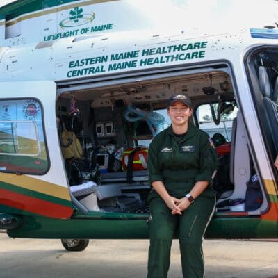 Flight Nurse Melissa Dufault by a LifeFlight helicopter.