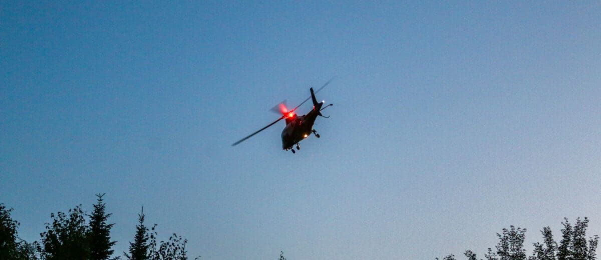LifeFlight helicopter taking off over Maine woods