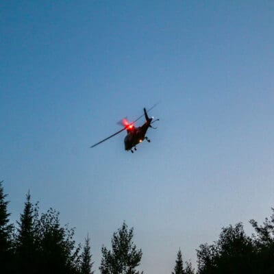 LifeFlight helicopter taking off over Maine woods
